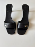 Mules Gucci nere con dettaglio G in metallo