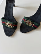 Mules Gucci GG Canvas nere con nastro Web e logo GG dorato